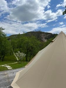 a view from inside of a white tent with a mountain at Tinutul Luanei Glamping Resort in Bozioru