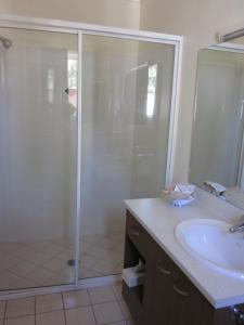 a bathroom with a shower and a sink at Maynestay Motel in Gunnedah