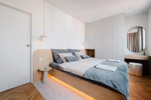 a bedroom with a large bed and a mirror at BeComfy - Old town apartment Bratislava in Staré Mesto