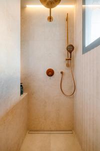 a bathroom with a shower with a shower head at BeComfy - Old town apartment Bratislava in Staré Mesto +25 photos