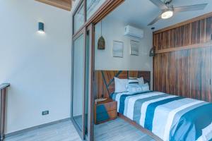 a bedroom with a bed and a glass wall at Amazing 2 bedrooms apartment with a pool in Sayulita in Sayulita +44 photos