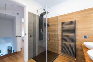a bathroom with a shower with a glass door at Spettacolare vista isola Terrazza e idromassaggio in Noli +51 photos