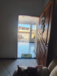 a door to a room with a view of a courtyard at Temporada em Piúma in Piúma