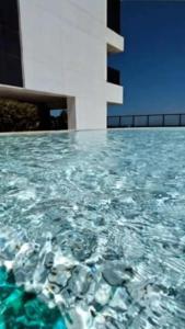 a view of a pool of water with a building at Luxury Paiva Flat in Recife