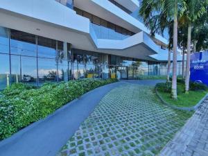 a building with palm trees in front of it at Luxury Paiva Flat in Recife