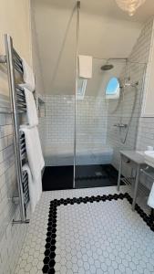 a bathroom with a shower with a glass door at The Stables Kildare - adults only in Kildare