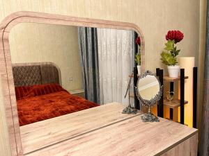 a bedroom with a mirror on a wooden table at Sumqayıt Bulvar in Sumqayyt