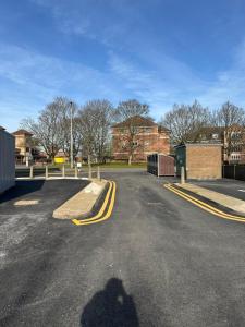 a shadow of a person standing on a street at Train Station Apartments- 2 Beds-1 Beds in Scunthorpe
