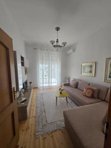 a living room with a couch and a table at Sea view Captain Apartment Durres in Durrës
