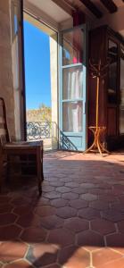 a porch with a bench and a view of the ocean at Domaine de la Ferme de Tumbrel in Neuville-Bosc