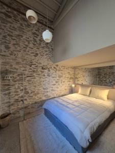 a bedroom with a large bed in a brick wall at the Workshop in Plomari +23 photos