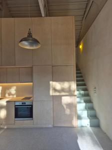 a kitchen with a staircase leading up to a building at the Workshop in Plomari