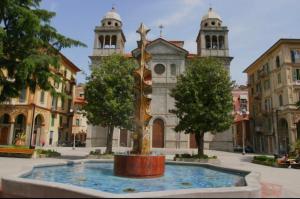 a fountain in front of a building with two towers at Casa Carlo La Spezia in La Spezia