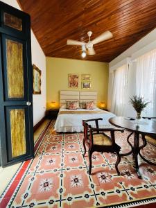 a bedroom with a bed and a table and a table sidx sidx at Hotel Boutique Ana Lorenza in Mompos +83 photos