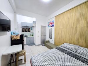 a small room with two beds and a kitchen at Happy Homes Guest House in Legazpi