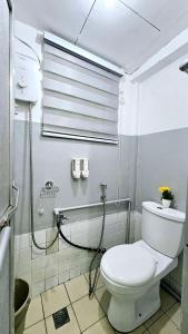 a bathroom with a white toilet and a shower at Happy Homes Guest House in Legazpi +28 photos