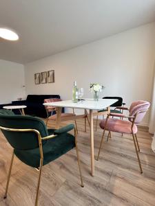 a dining room with a white table and chairs at Apartment NovumSpot Free ParkingSpot in Prešov +17 photos