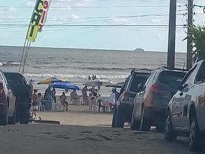 a group of parked cars parked on the beach at Casinha beira praia Gaivota in Itanhaém