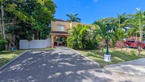 a house with a street light in front of a driveway at MoBay Las Palmas in Montego Bay