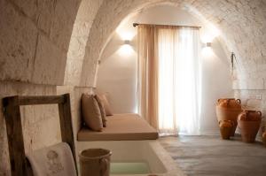 a room with a couch in a room with a window at Palazzo Marconi in Locorotondo +18 photos