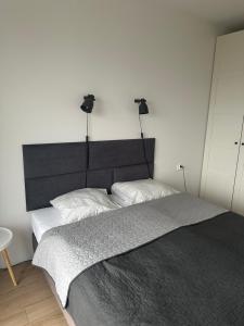 a bedroom with a large bed with lights on the wall at ORKAN 2 in Kuźnica