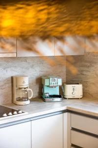 a kitchen with three toasters on a counter at Sirin Luxury Suites Groundfloor in Haraki