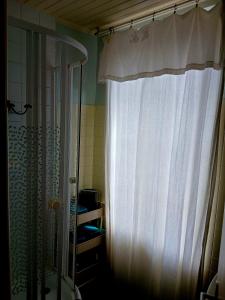 a shower with a white curtain in a bathroom at B&B chez Annie in Saint-Martin-de-Gurçon +86 photos