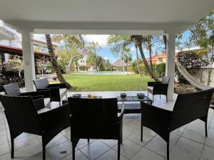 un patio con sillas y una mesa y un césped en The Villa of Dreams, en Cancún