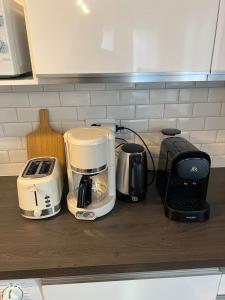 a counter with two coffees and a coffee maker on it at Classic - Paris, DisneyLand, Villepinte Expo, CDG in Sevran