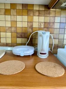 a blender sitting on top of a wooden table at PELEKAN rooms and apartments Athina 33 in Pefkohori