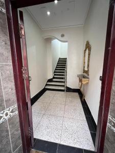 an open door to a hallway with a staircase at Appartement 1 luxueux vue mer in Al Hoceïma