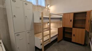 a small room with bunk beds and cabinets at Calm Stay in Teo
