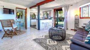 a living room with a couch and a table at Sea Breeze Apartment in Wilderness