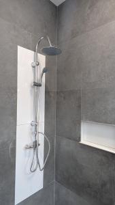 a shower with a glass door in a bathroom at Calm Stay in Teo +29 photos