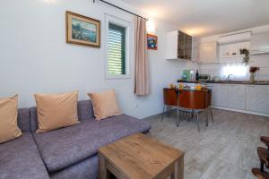 a living room with a couch and a kitchen at Apartman Donadina-Dalmatian heritage house in Trogir +29 photos
