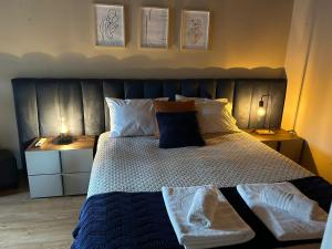 a bedroom with a large bed with two night stands at Casa dos Invernos in Paçô