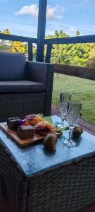 a table with a plate of food and wine glasses at Cabañas Teave in Hanga Roa