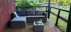 a couch sitting on a balcony with a table at Cabañas Teave in Hanga Roa
