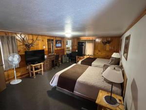 a hotel room with two beds and a desk at Trails end motel in Dubois