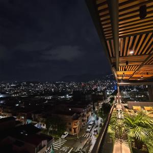 a view of a city at night at 4 Sur Hotel in Medellín