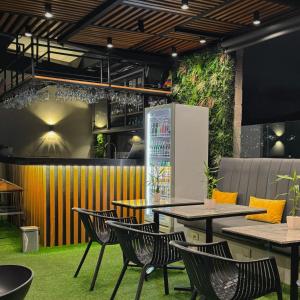 a restaurant with tables and chairs and plants at 4 Sur Hotel in Medellín