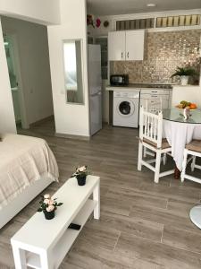 a kitchen and living room with a bed and a table at Palmeras 312 Suites in Marbella