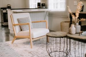 a chair and a table in a living room at Platteland Cottage in Clarens