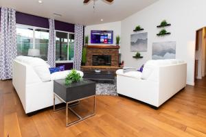 a living room with two white couches and a fireplace at Amethyst Hearth - Family Spa Serenity, Zoo, Beach, Disneyland, Legoland in Vista