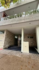 a brick building with a sign in front of it at Alma in La Plata