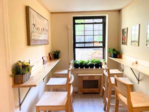 a restaurant with wooden tables and chairs and a window at Interfaith 21st Street in New York