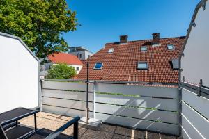 a balcony with a fence and a table and a building at Ankerlicht in Norddeich