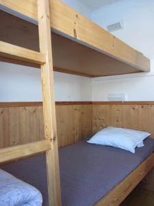 a bedroom with two bunk beds in a room at Klarälvens Camping in Stöllet