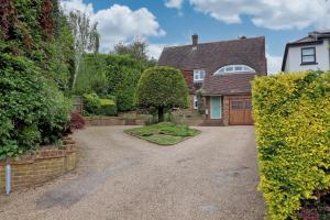 a driveway in front of a house with a garage at Luxury 4-Bed Family Home in Epping with Parking by LMV Property in Epping