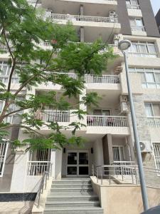 a building with stairs in front of it at Comfy Hotel Apartament in Madinaty